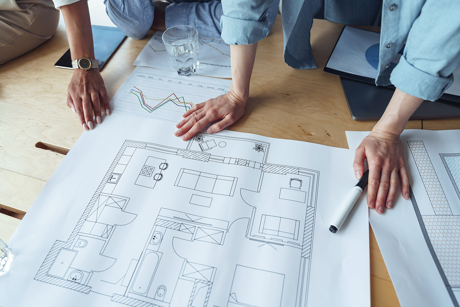 Close up hands of professional design engineers working with project documents in modern office